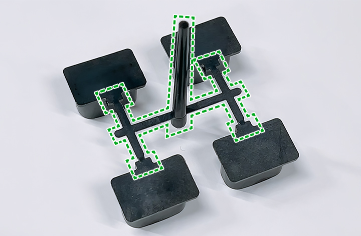 Through our hot runner molding system, we have reduced the unnecessary resin (in the area outlined with a dashed line) that is inevitably formed with the cold runner method.